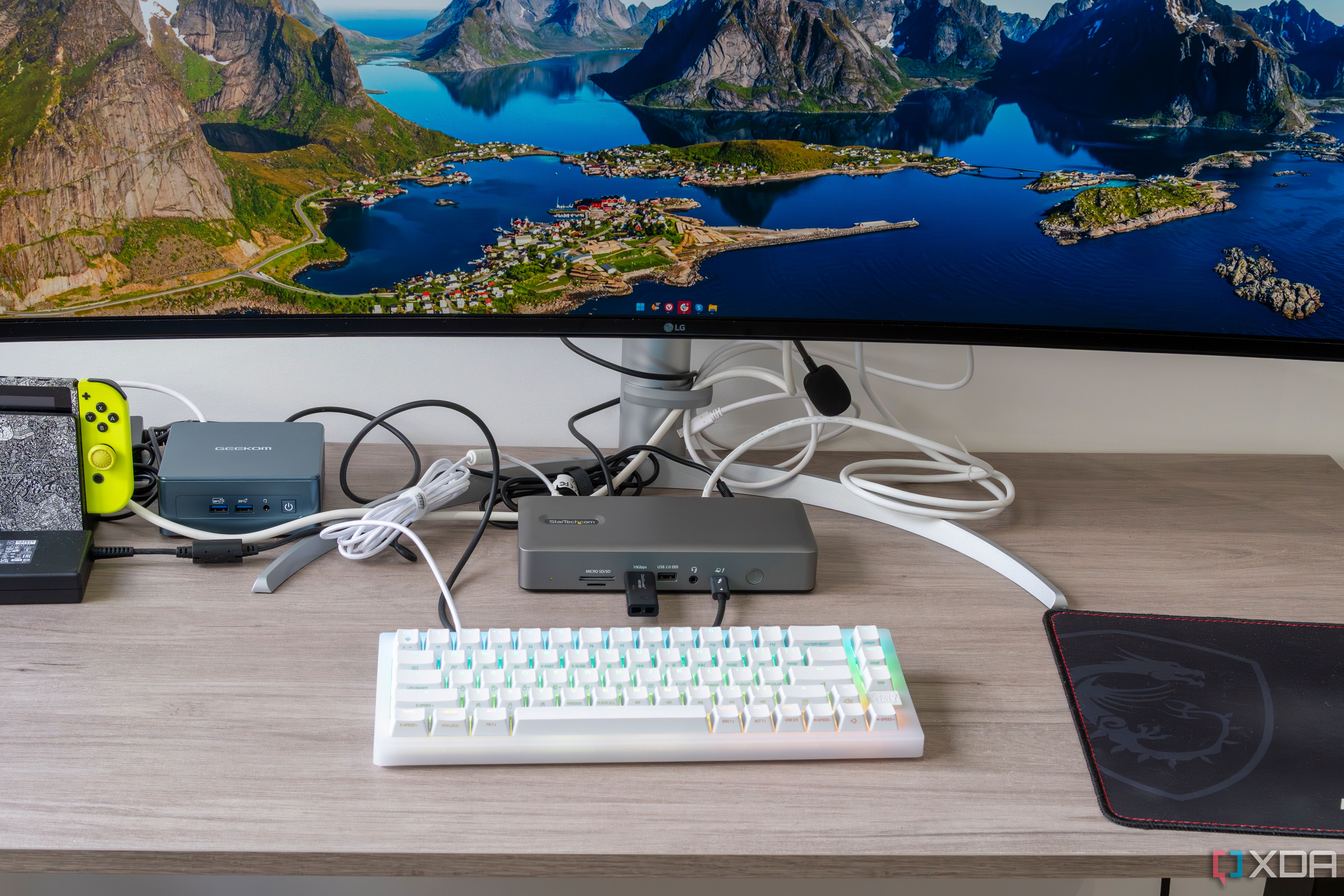 A desk setup with a StarTech ocking station connected to multiple peripherals