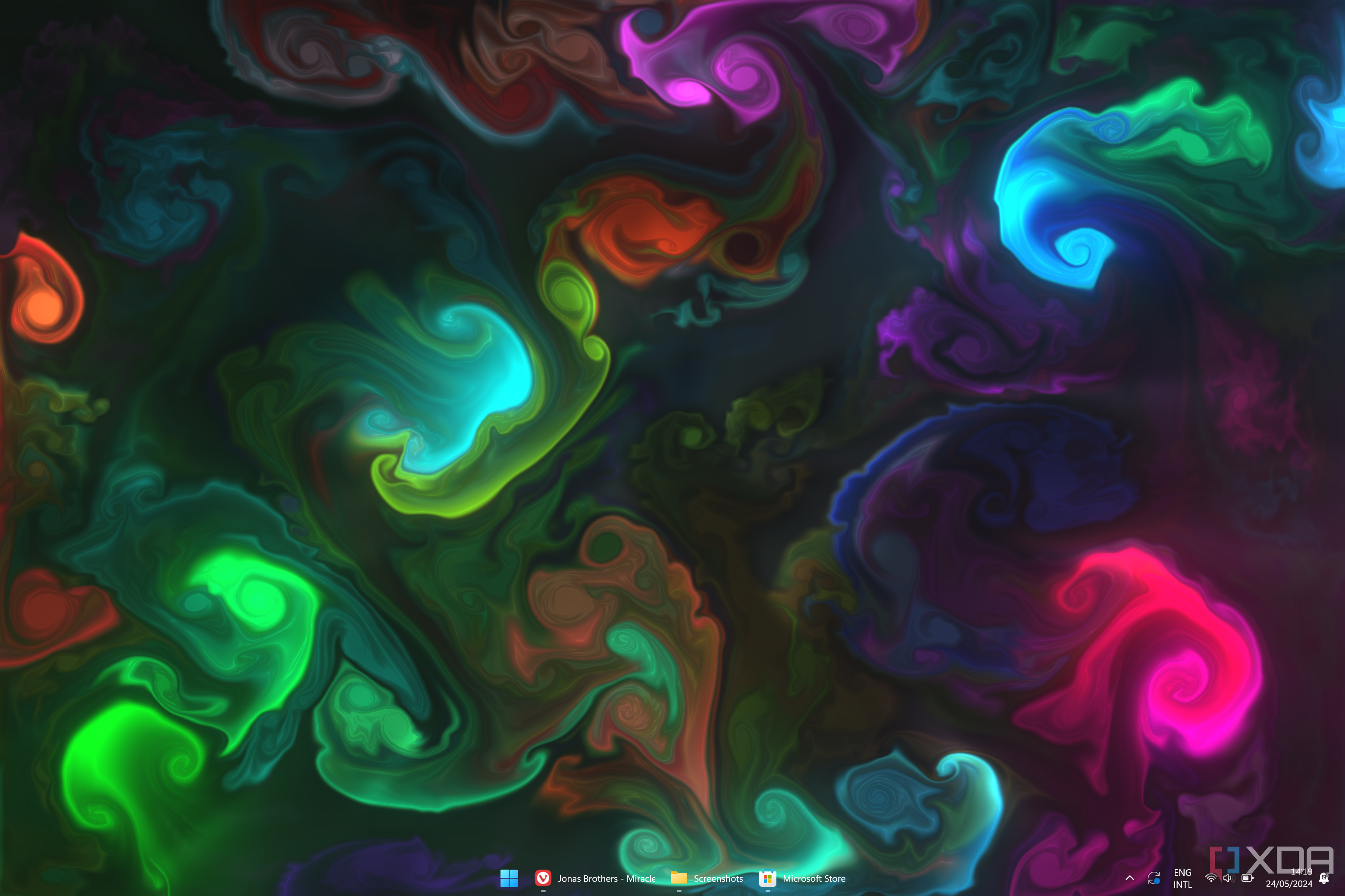 Screenshot of a Windows 11 desktop with a background with fluids of different colors in a black background