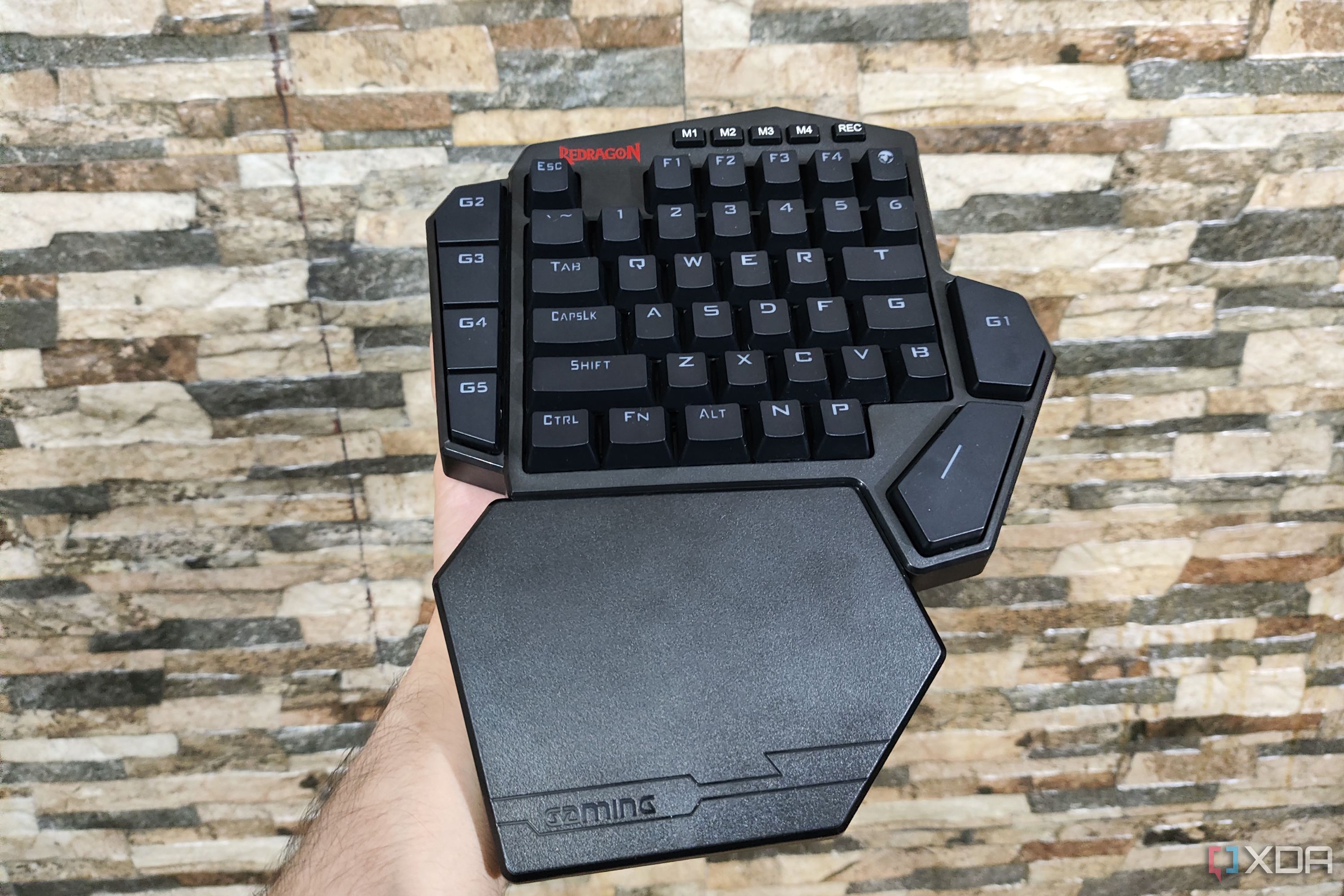 Una persona sosteniendo un teclado DITI Redragon K585