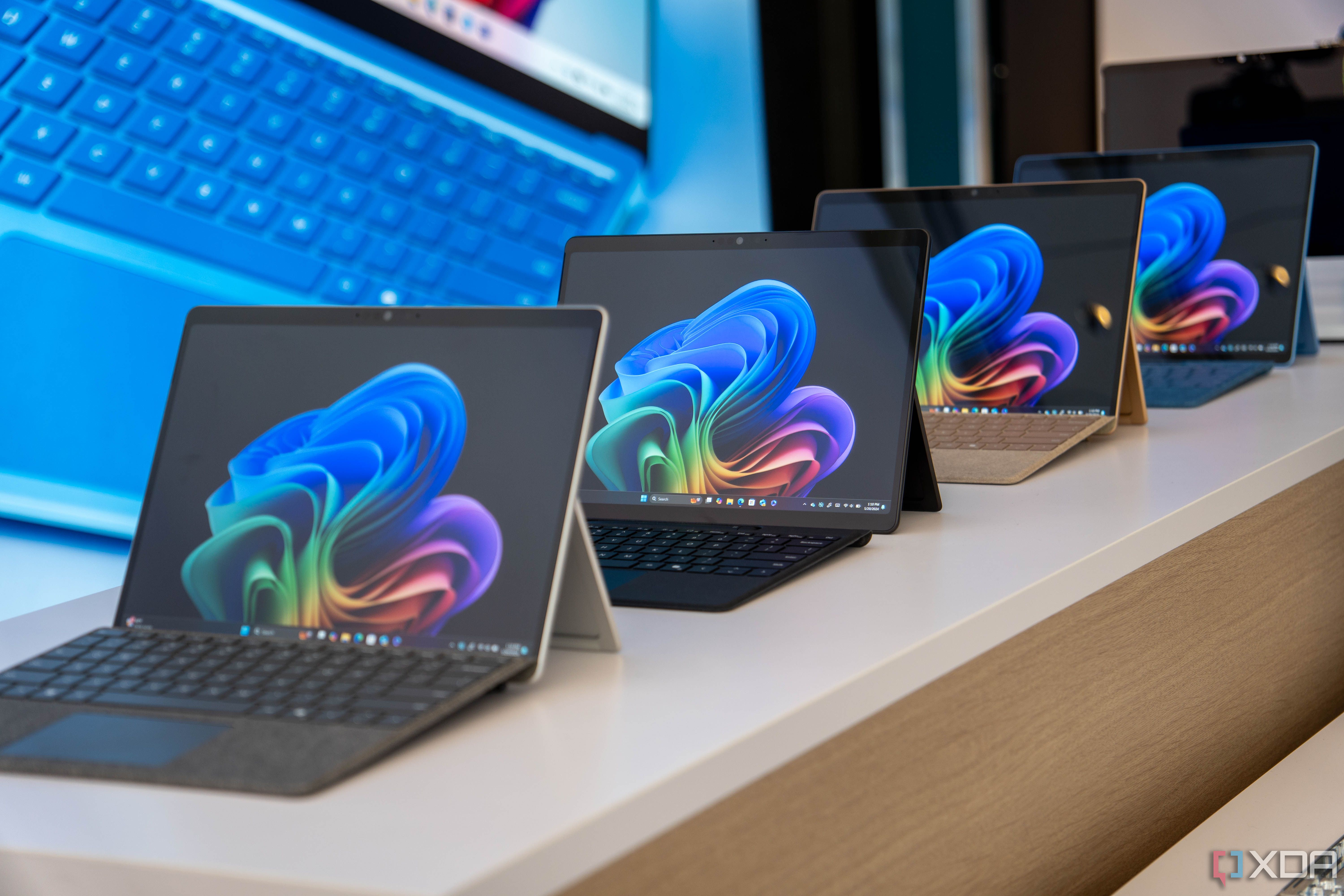 Surface Pro 11 devices on display at a Microsoft event.