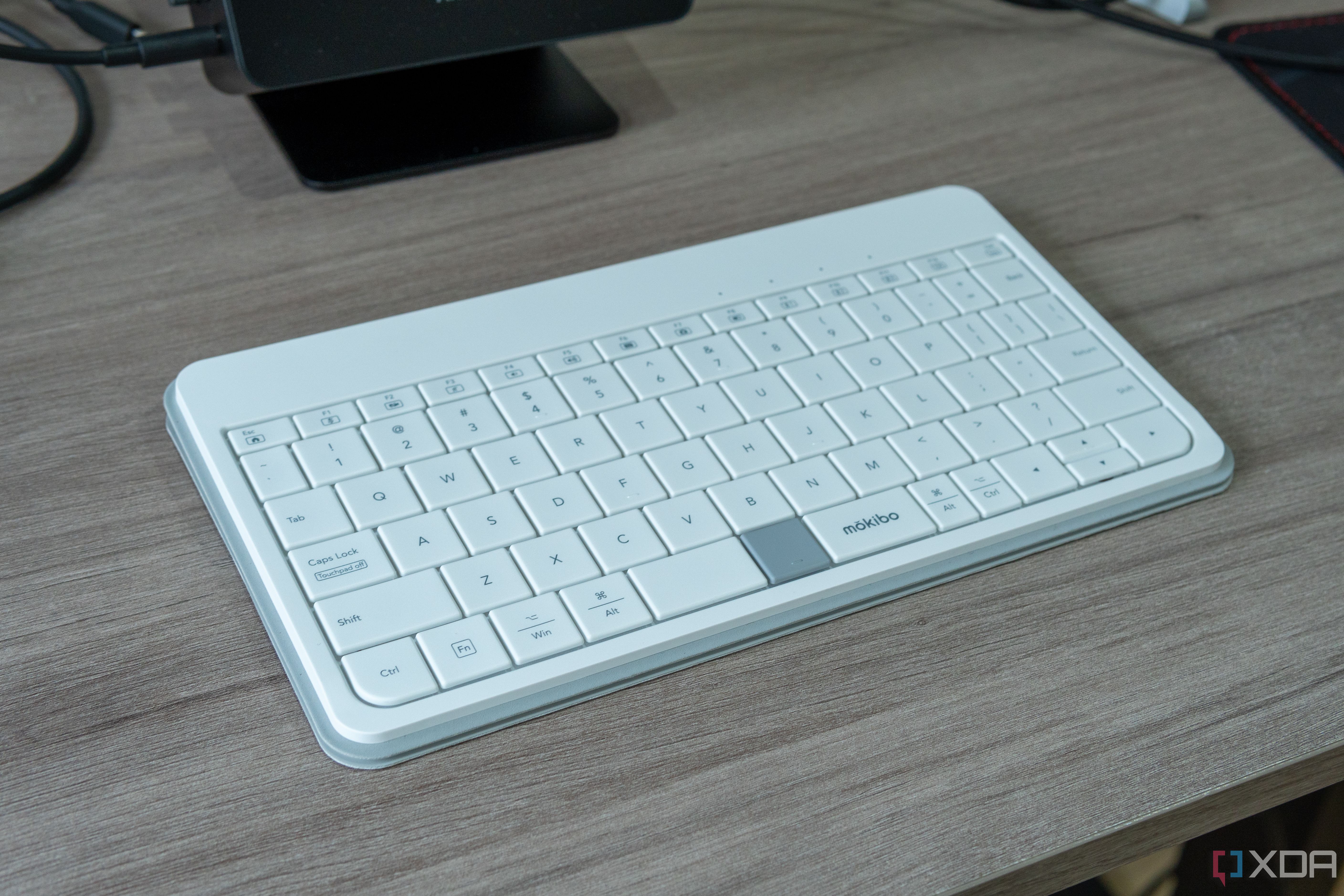 Angled view of the Mokibo Fusion Keyboard in front of a computer