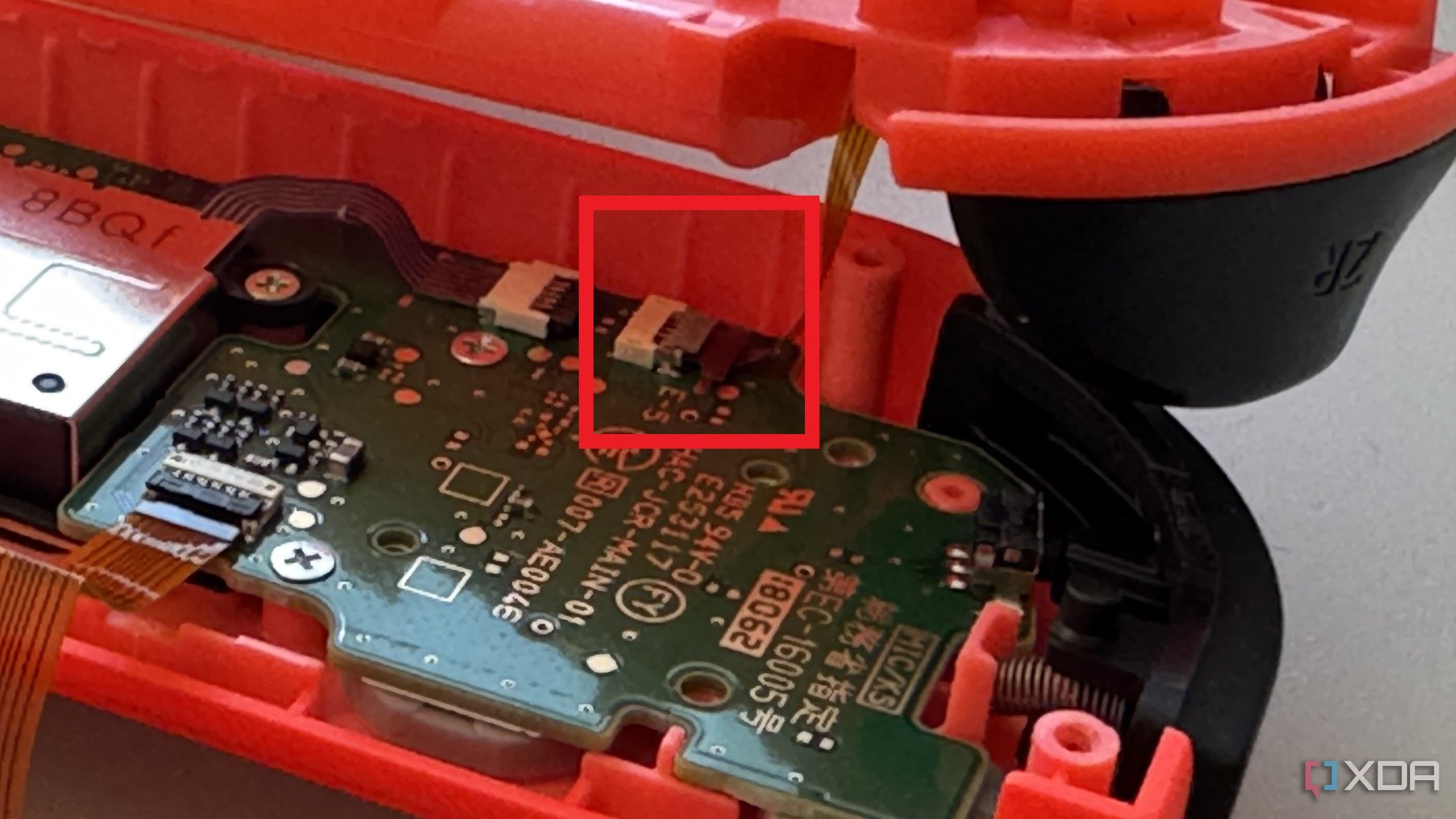 Placa base del Joy-Con derecho que muestra el conector del cable del botón ZR