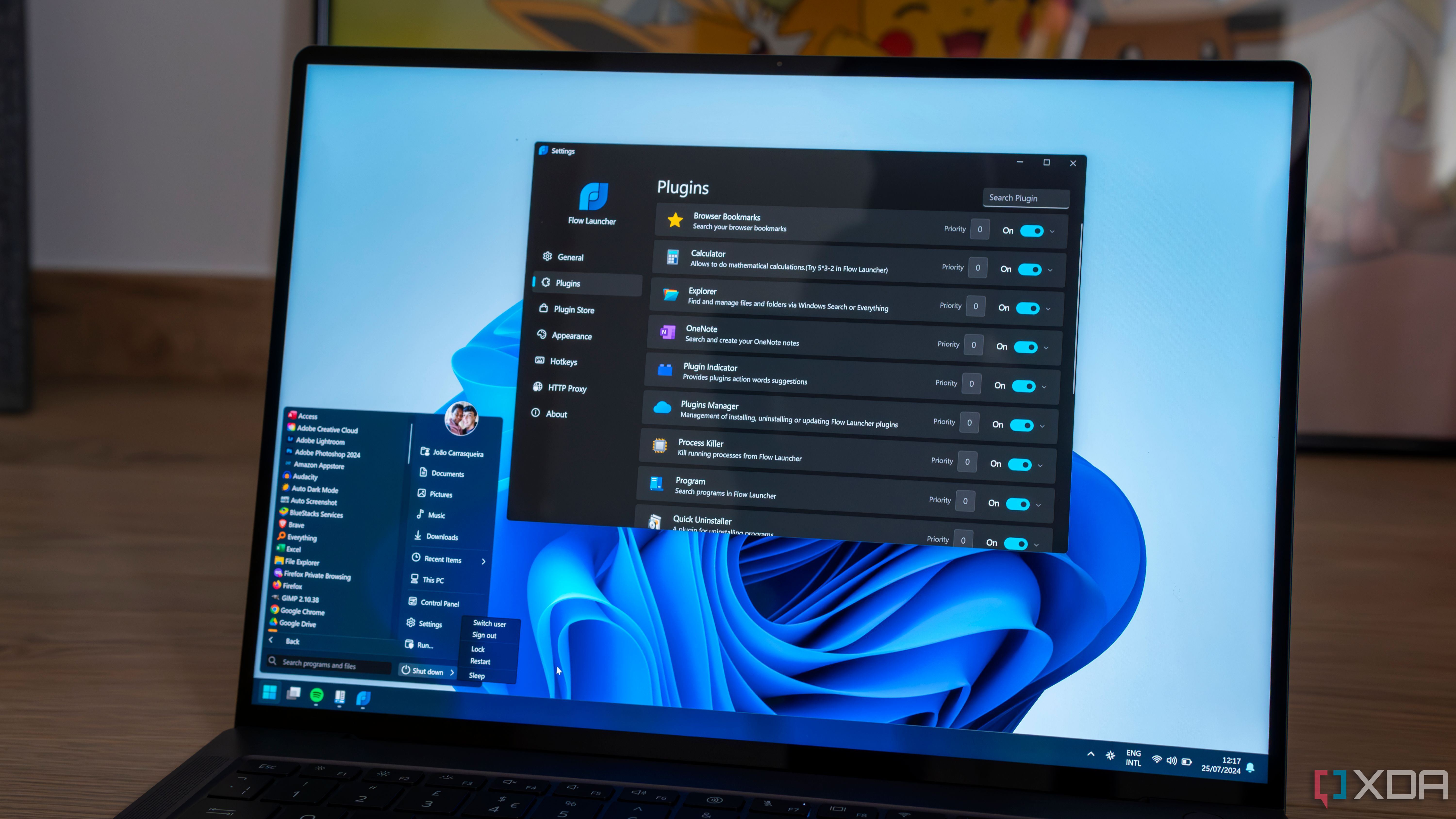 A Windows 11 laptop with a Start menu powered by StartAllBack and the Flow launcher settings window open