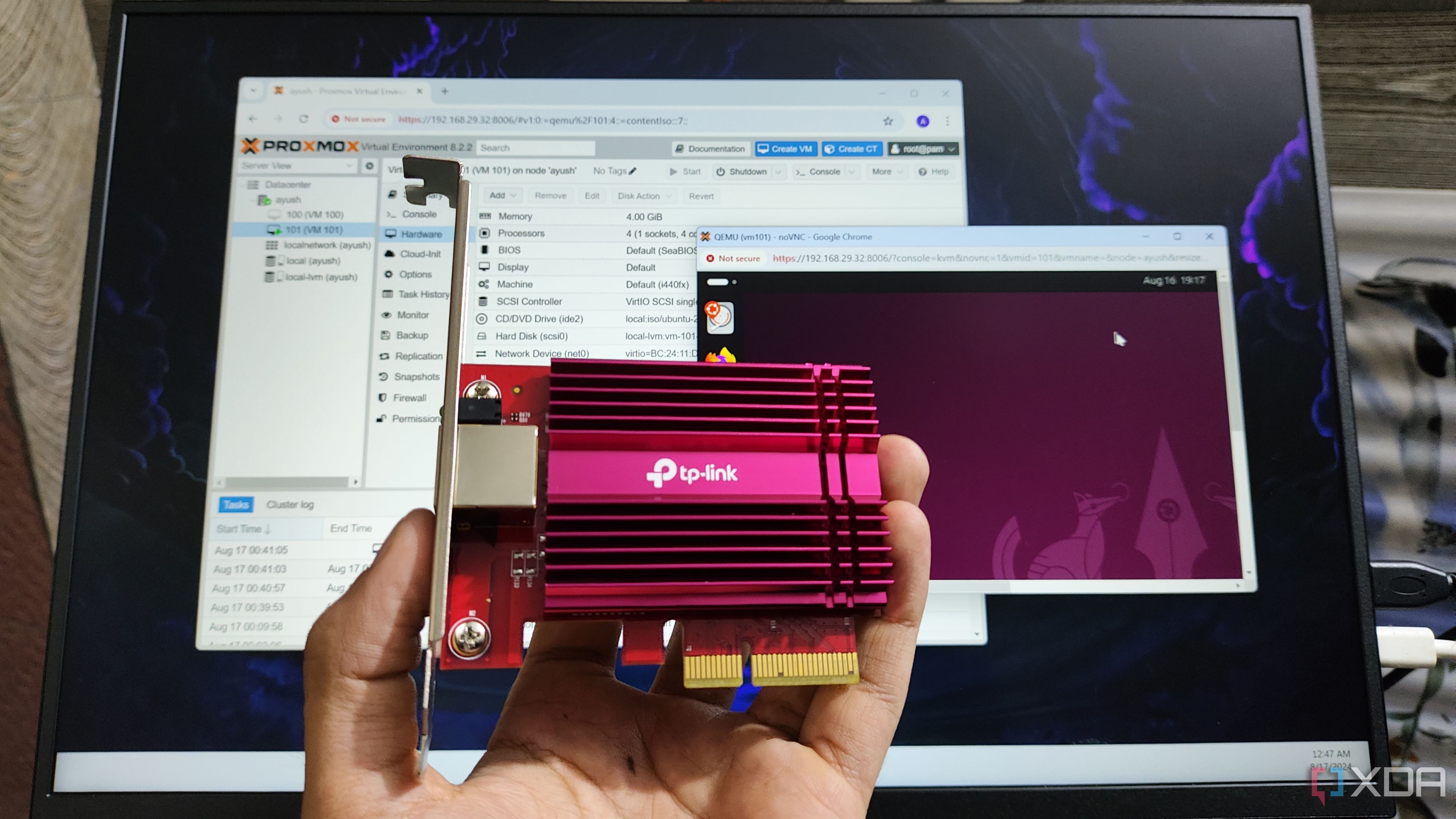 A person holding a 10GbE NIC in front of a monitor displaying the Proxmox UI