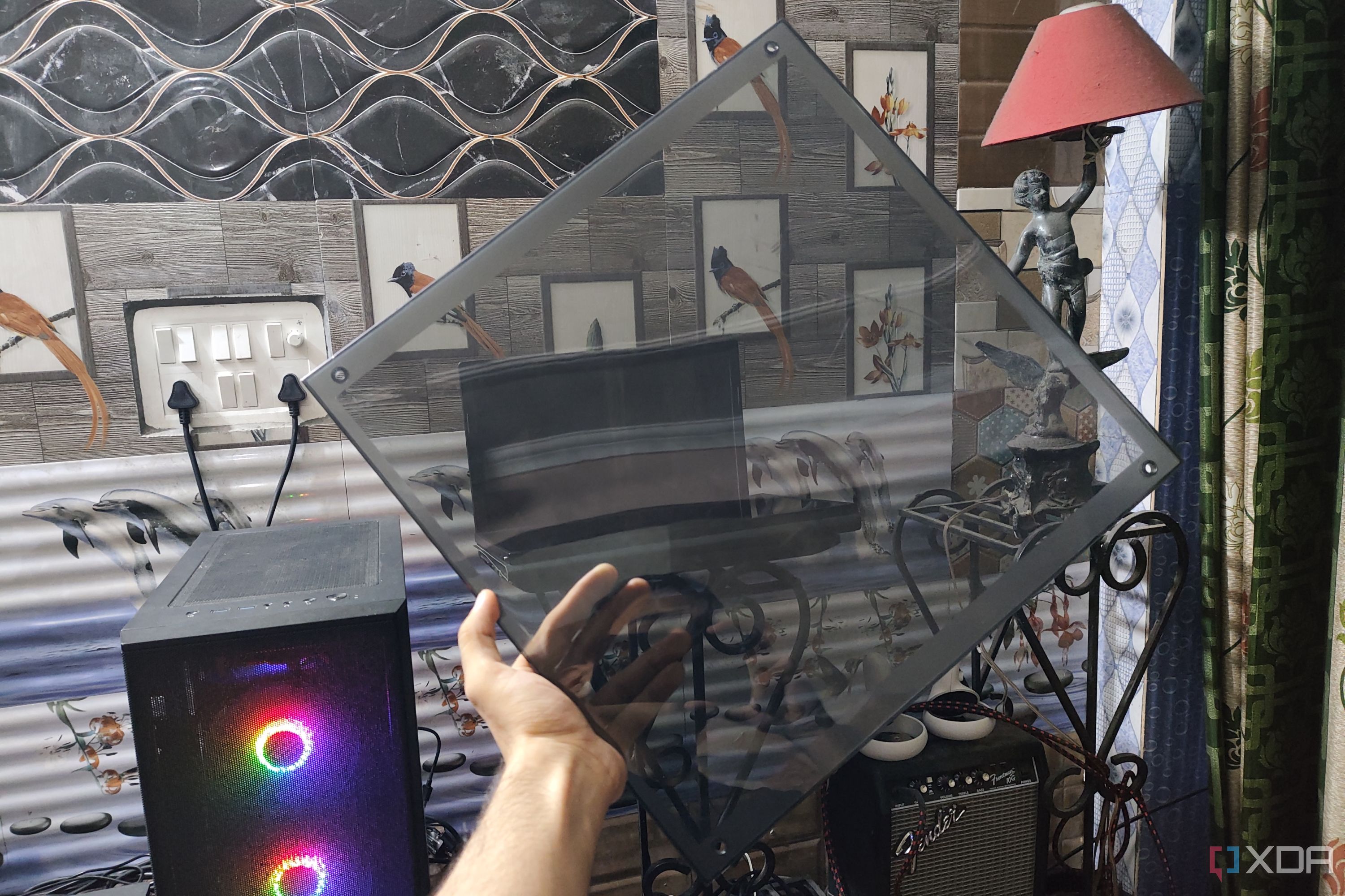 A person holding an acrylic glass panel