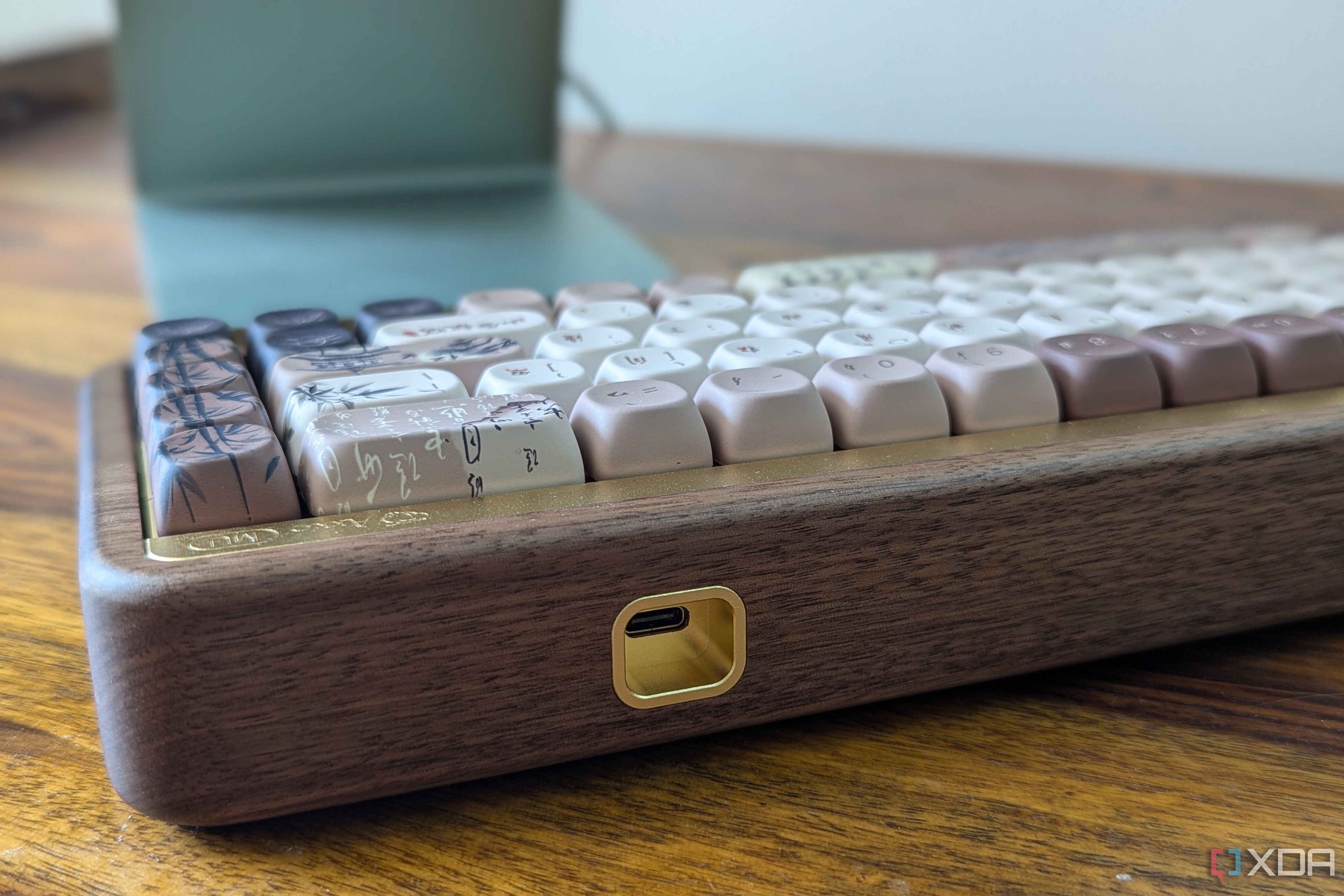 Close-up of a wooden mechanical keyboard on a wooden surface