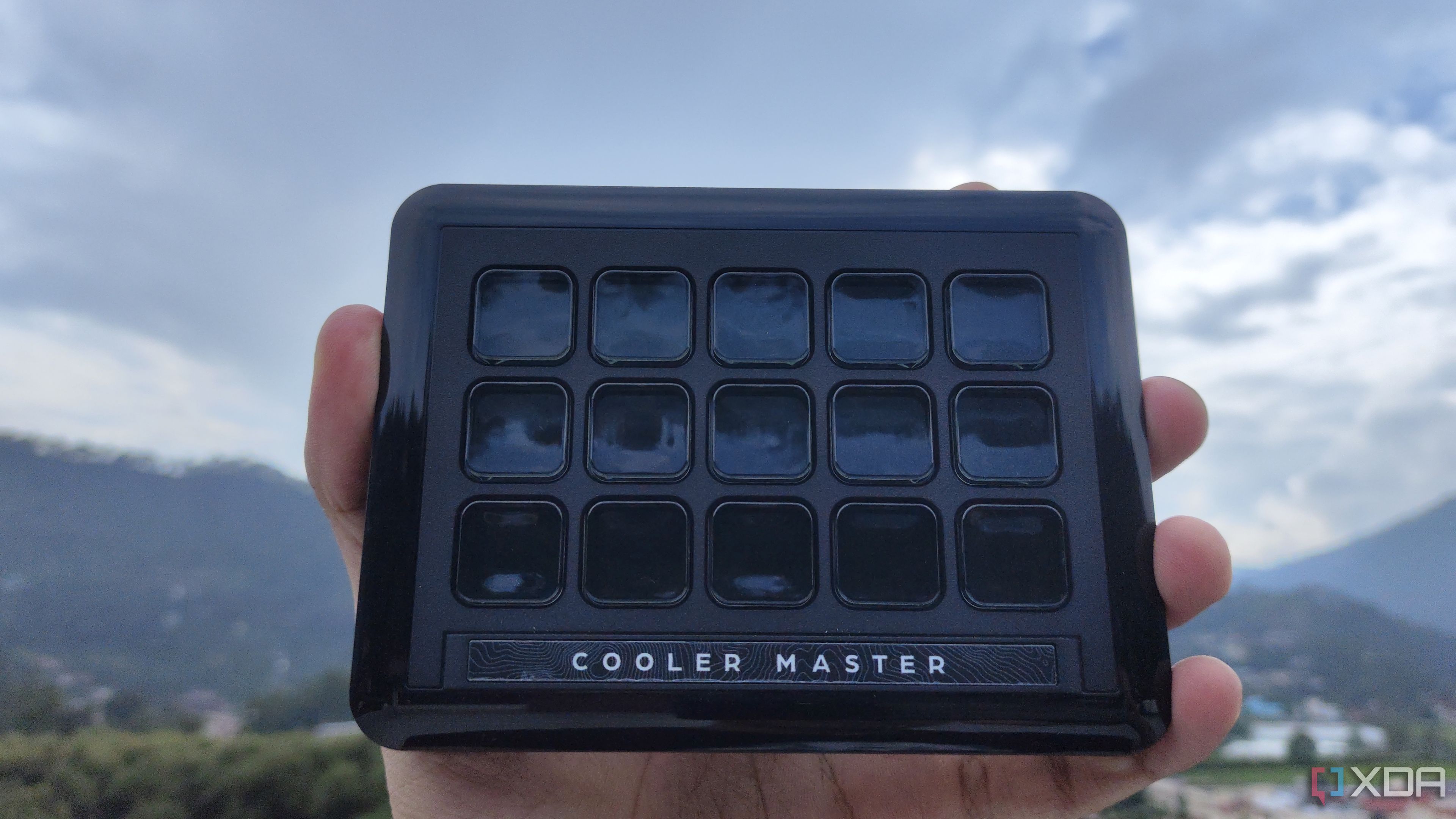 A person holding the 15-key IPS Display module of the Cooler Master MasterHUB