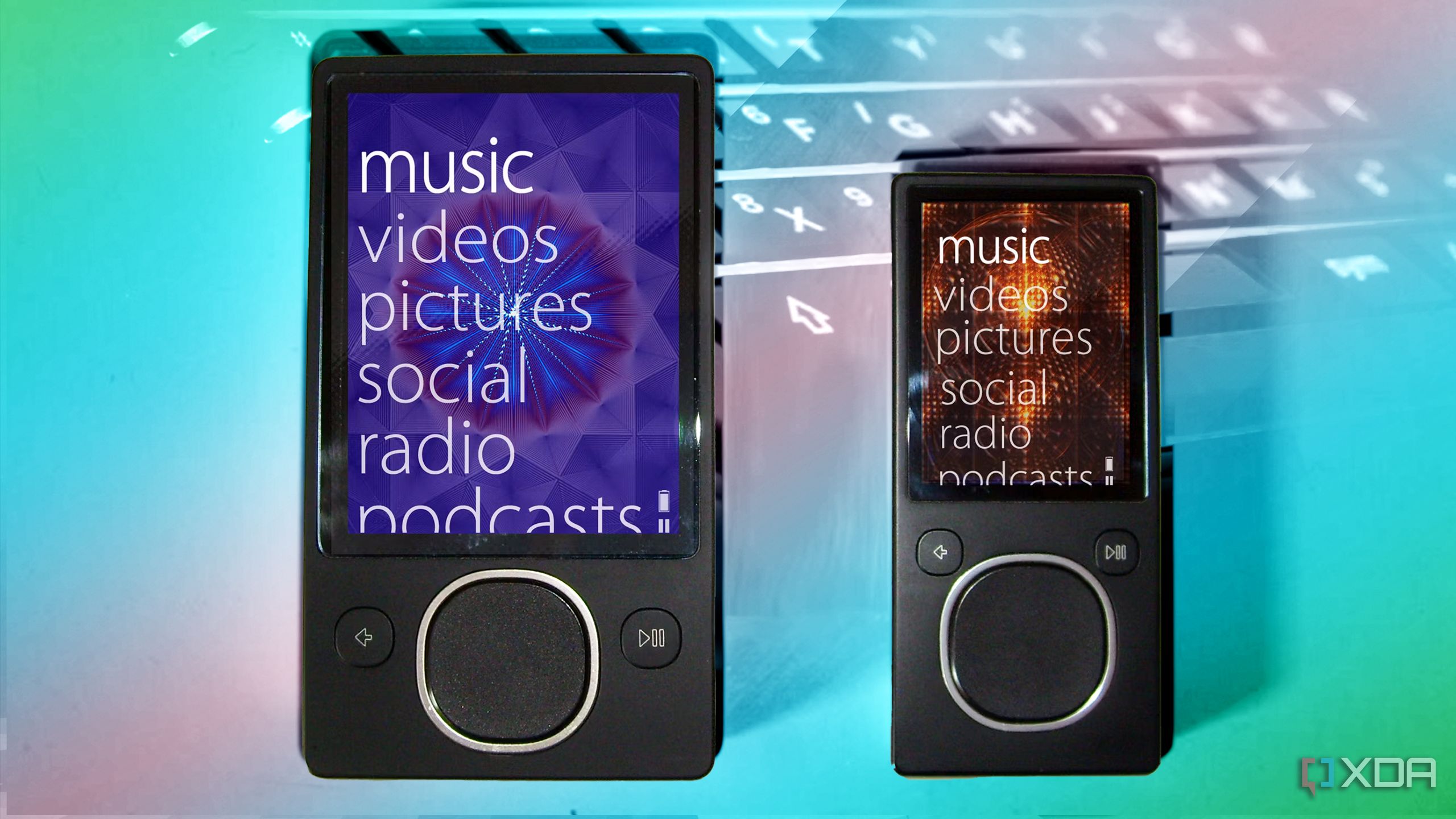 two zune devices over a pastel keyboard