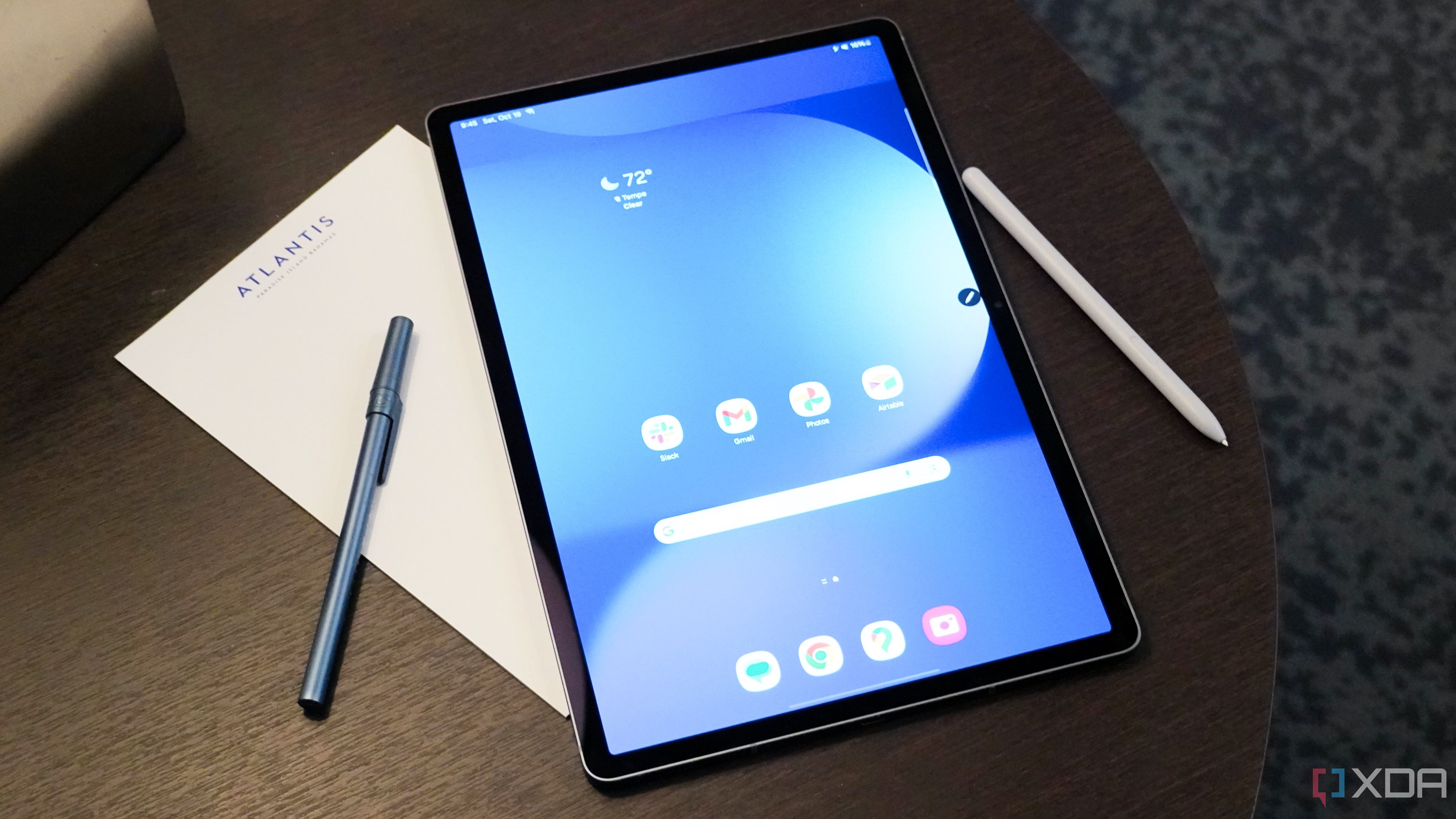 The Samsung Galaxy Tab S10+ with a pen and notepad on a small table.