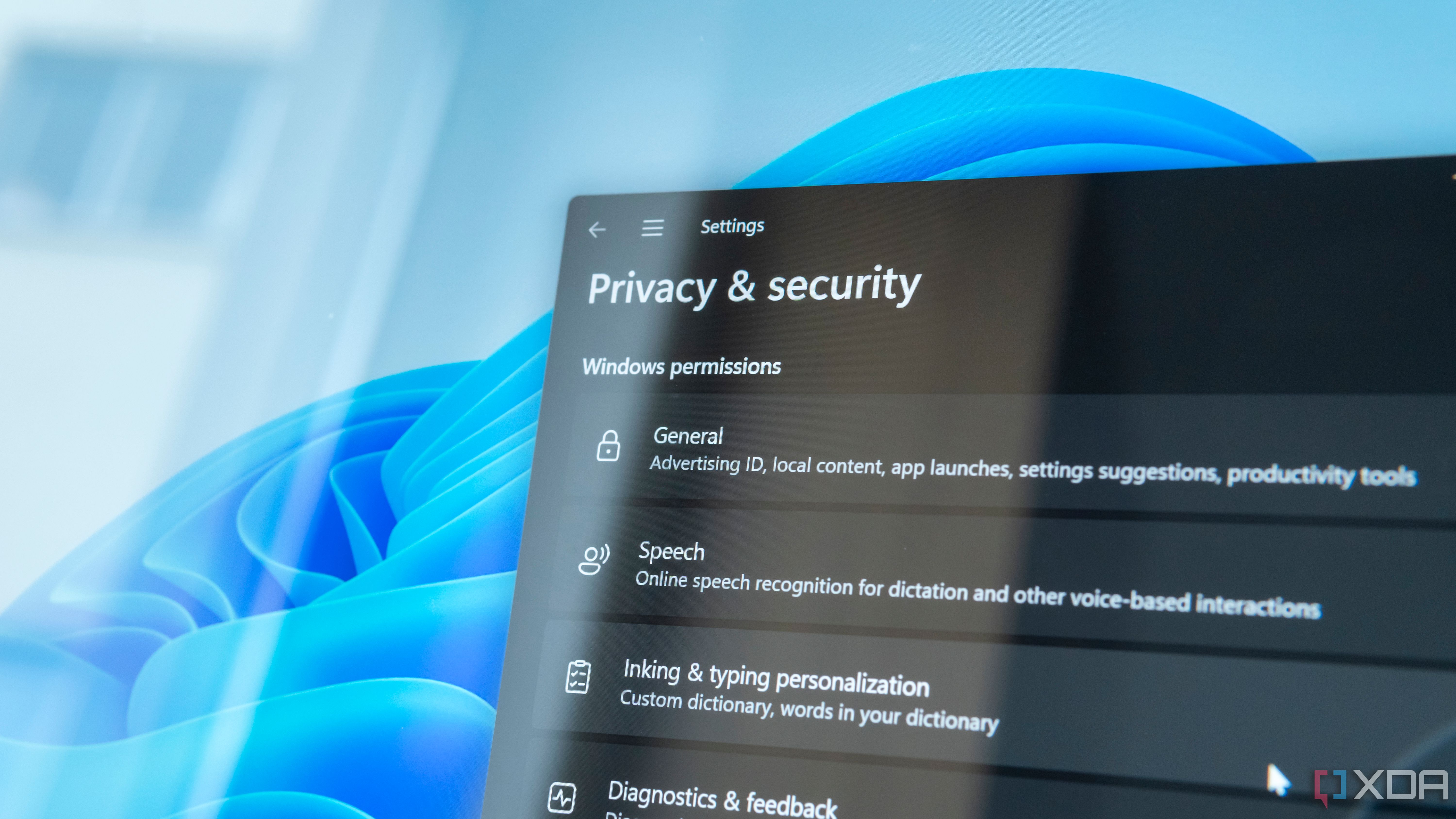 Close-up of a computer screen showing privacy and security settings in Windows 11, including text reading "Windows permissions"