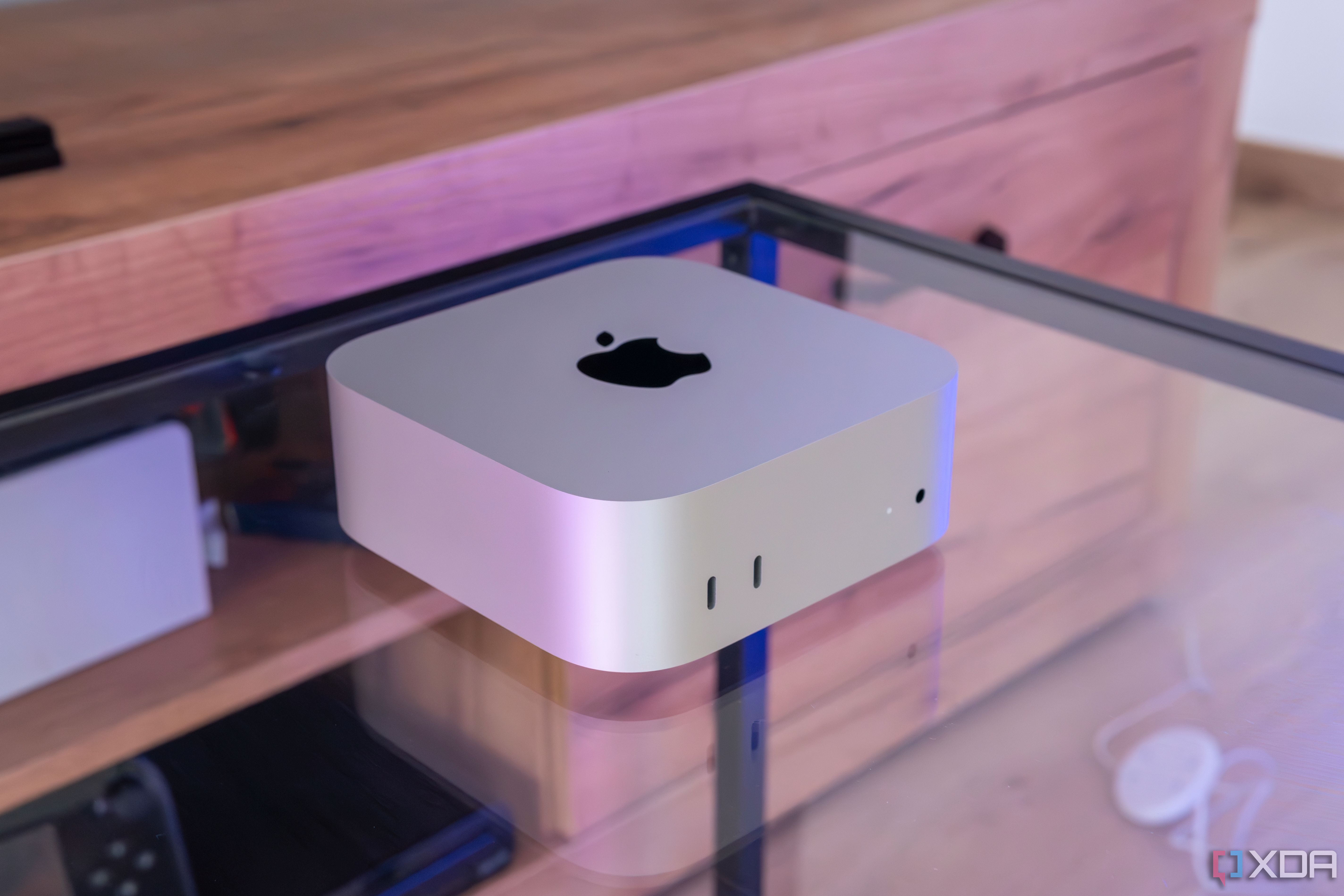 Angled view of the M4 Mac Mini on a glass table