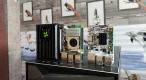 A Raspberry Pi 5, a Radxa X4, and a Libre Computer Alta SBC resting on top of a PC