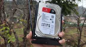 A person holding a 4TB Seagate HDD