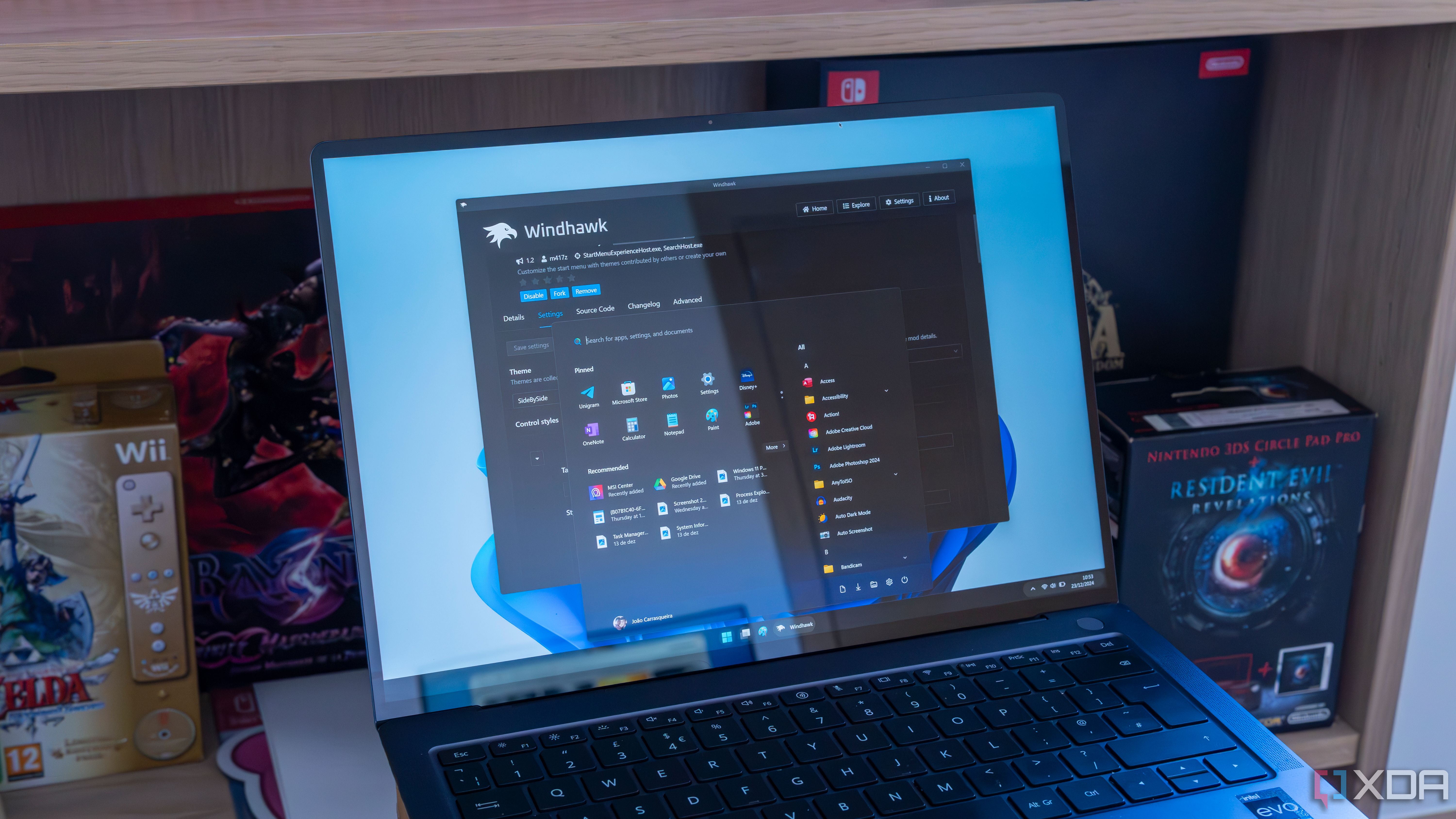 A laptop running Windows 11 and Windhawk with a customized taskbar and Start menu