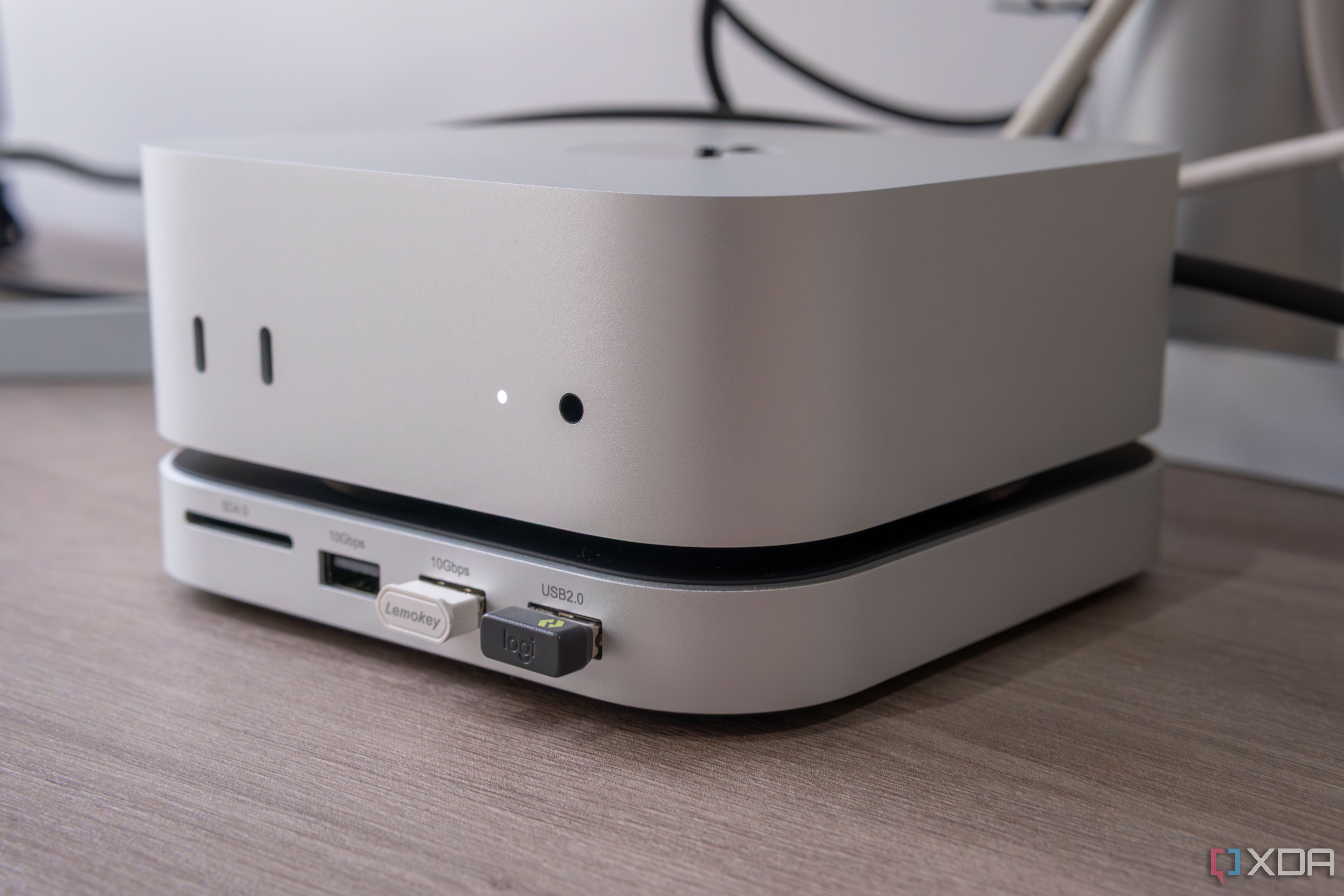 Close-up of an M4 mac Mini on top of a Satechi Stand & Hub with two USB dongles plugged in
