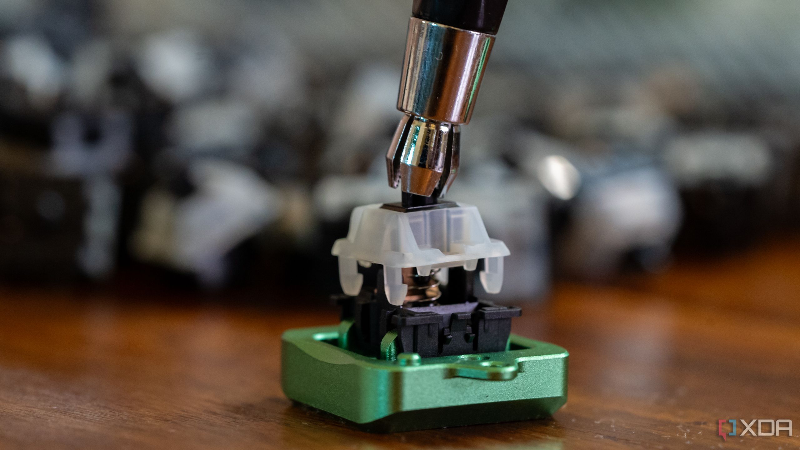 A switch stem holder in action during a keyboard switch disassembly