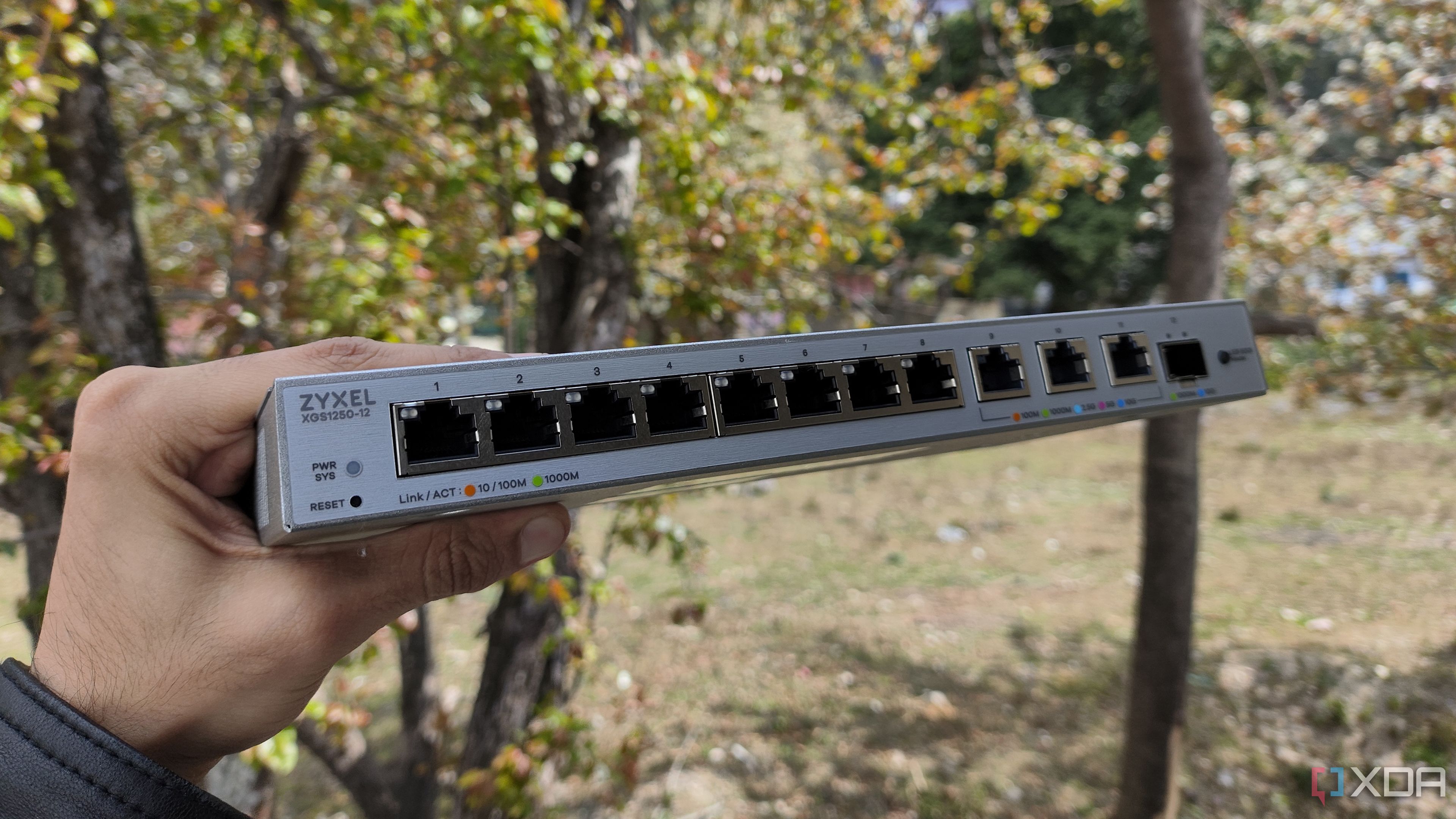 A person holding a Zyxel network switch