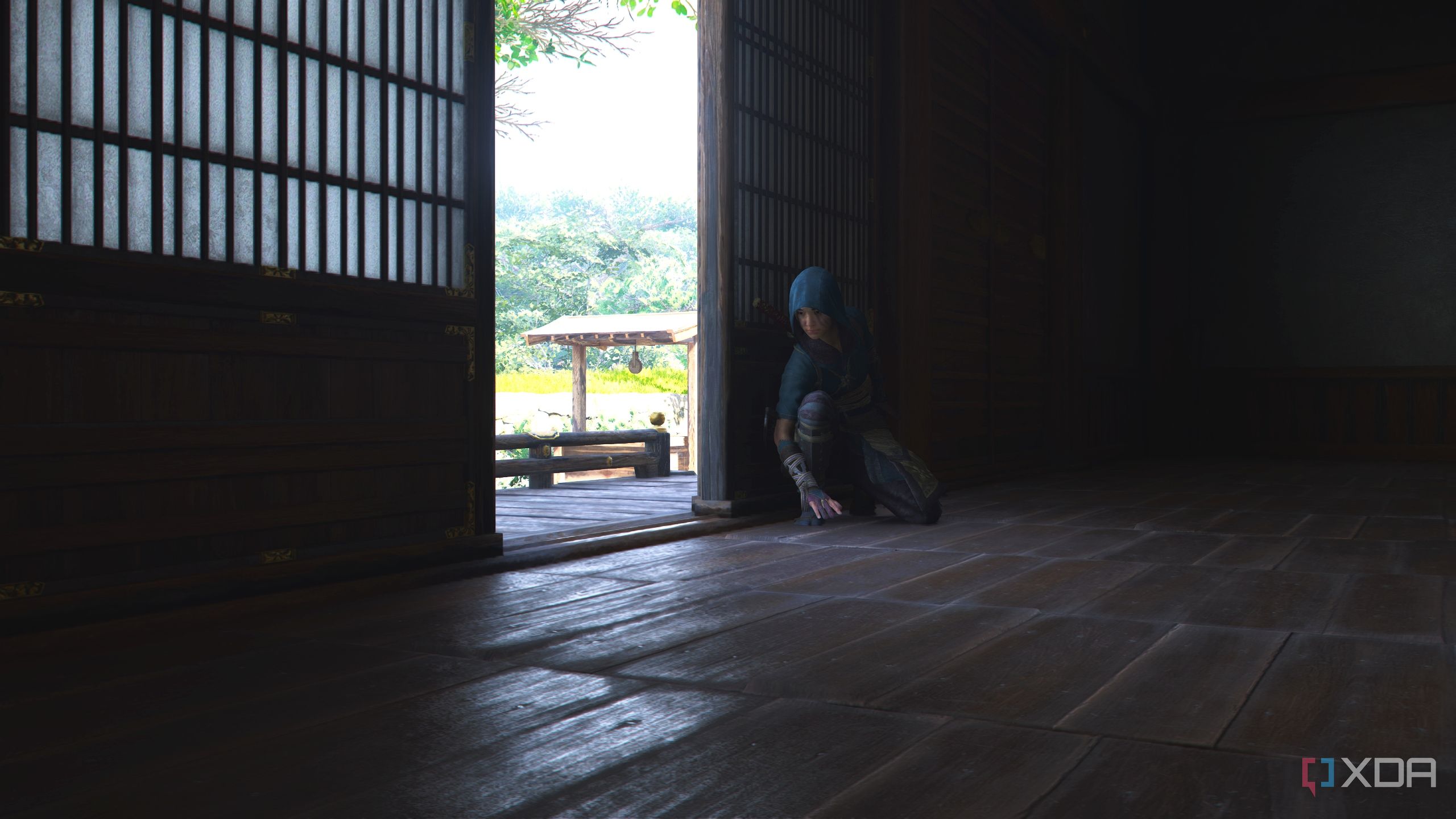 A screenshot from Assassin's Creed Shadows, showing Naoe, the female protagonist, crouching in the shadows.