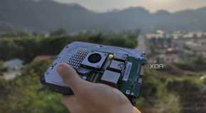 A person holding a Raspberry Pi and some storage drives