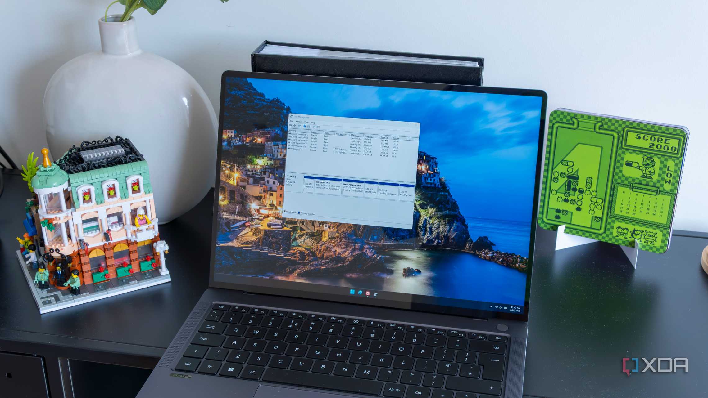 A Windows 11 laptop showing the Disk Management UI