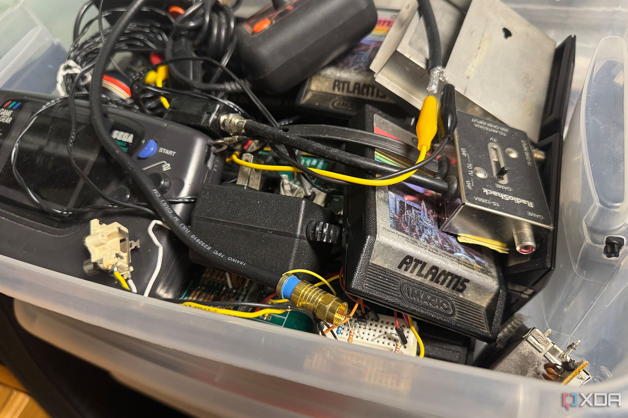 Atlantis games, Atari 2600, Game Gear, and other projects in a plastic storage container