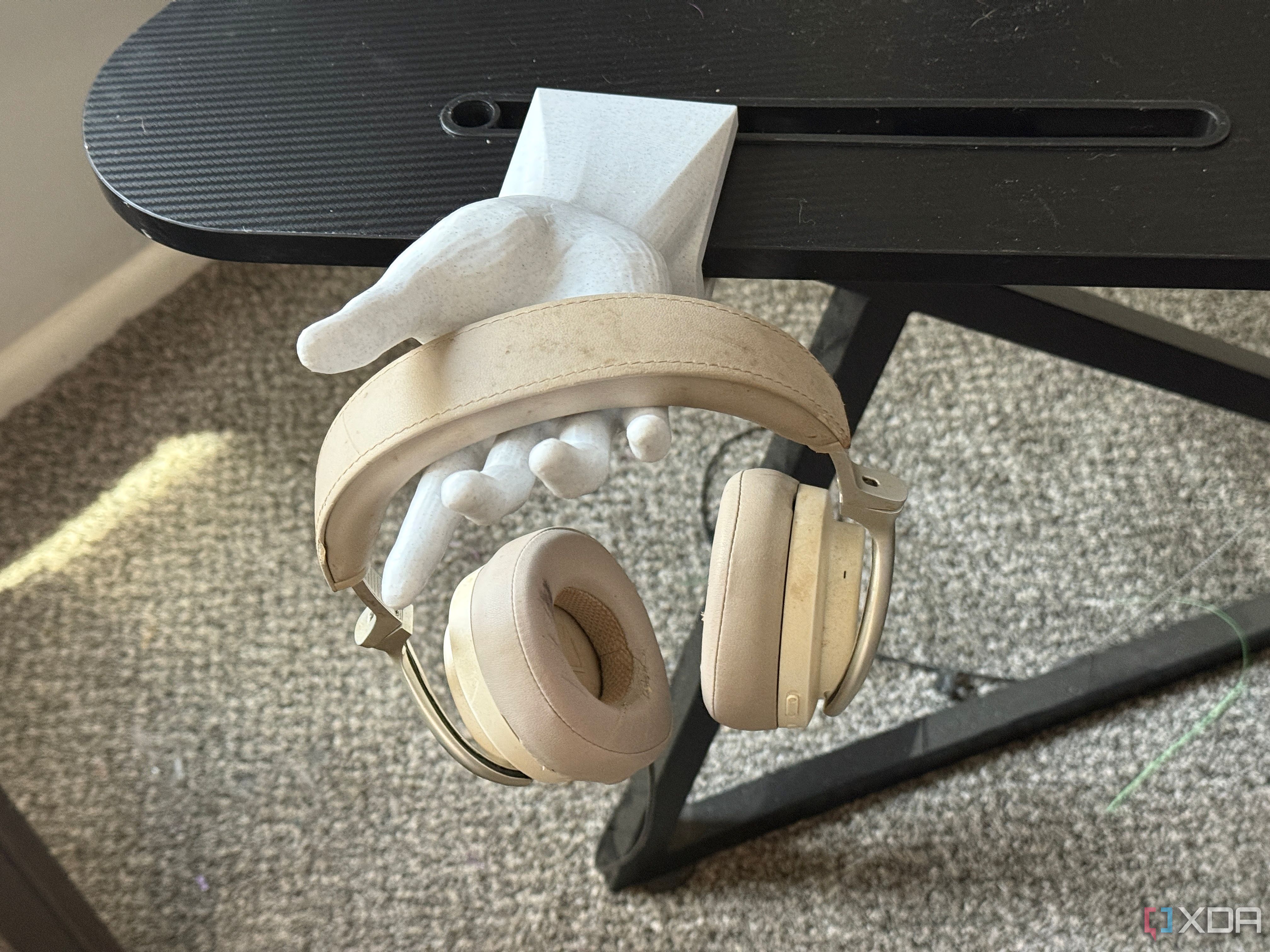 Hand headphones stand above second shot