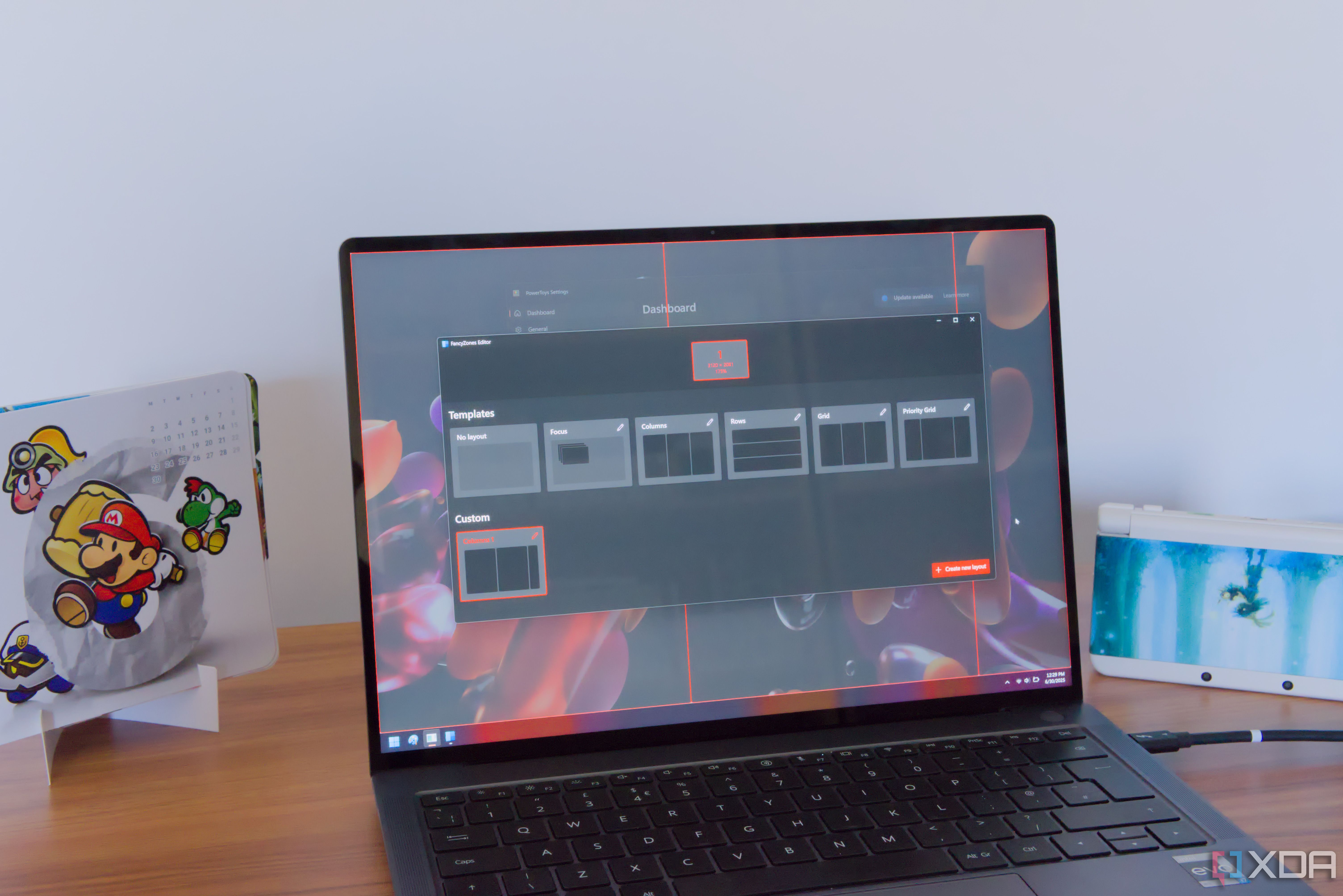 A Windows 11 laptop showing FancyZones layouts