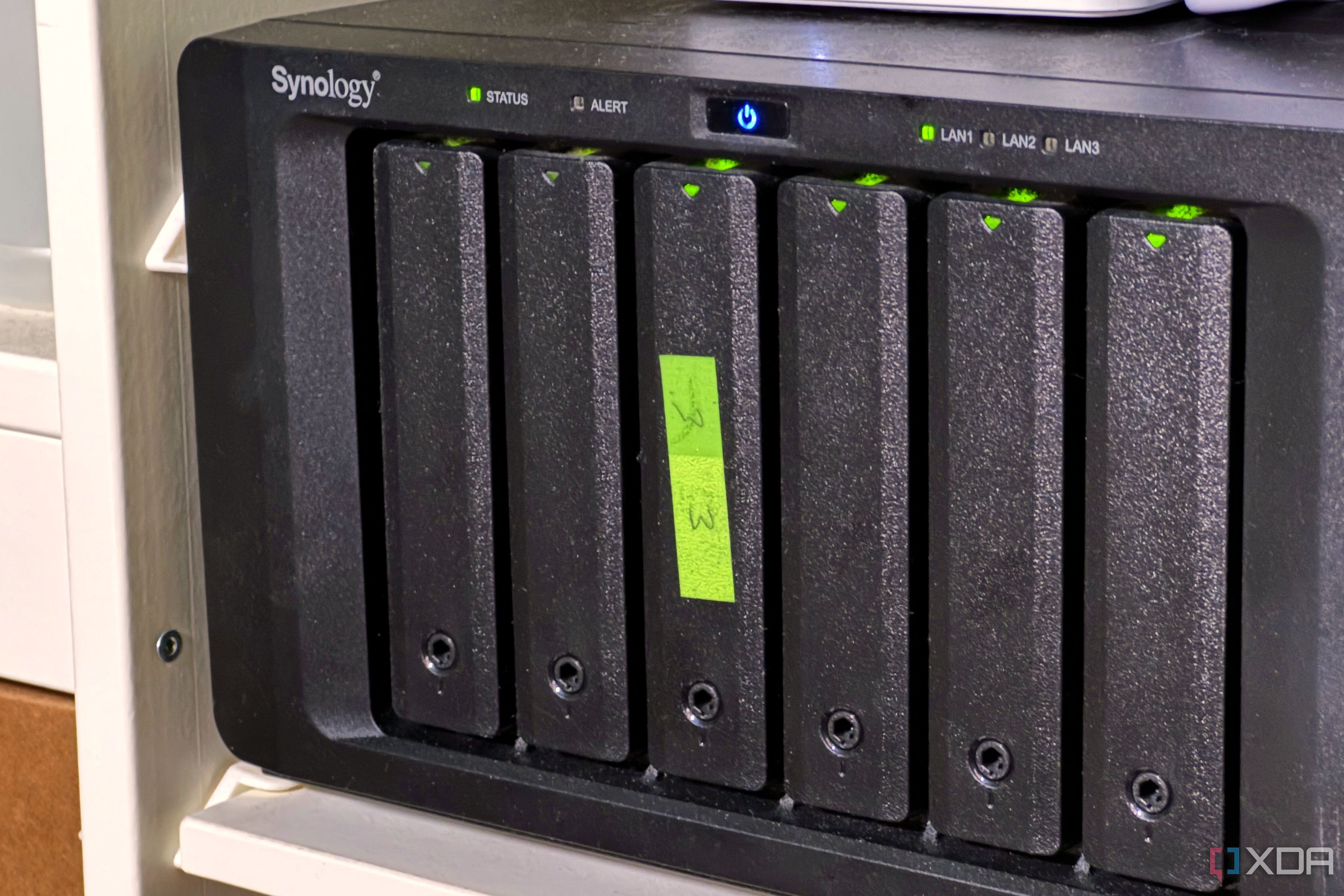 nas with green sticky label on the third drive sled
