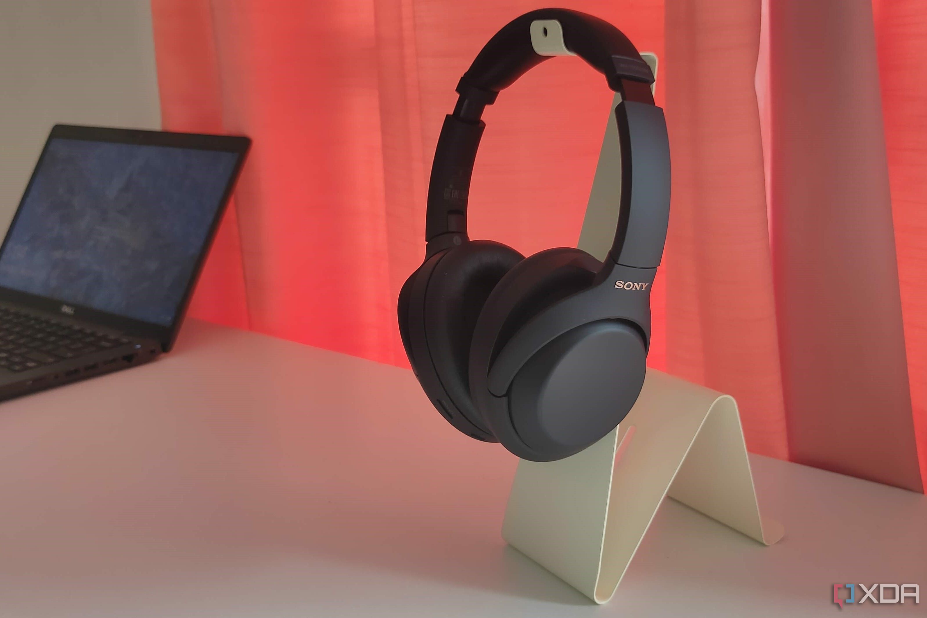 Black Sony headphones on a white stand