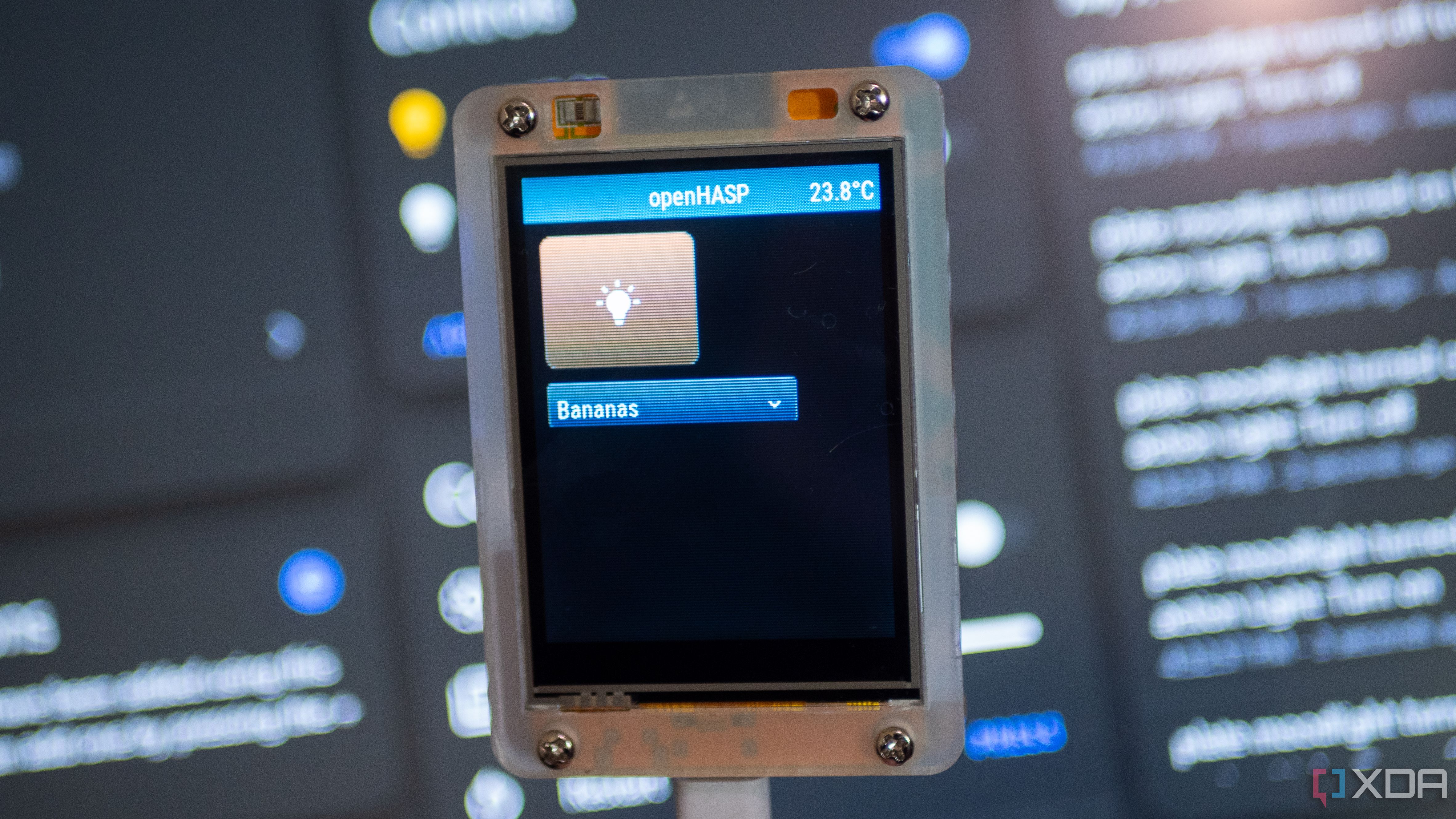 A light toggle and a dropdown on openHASP, with Home Assistant in the background
