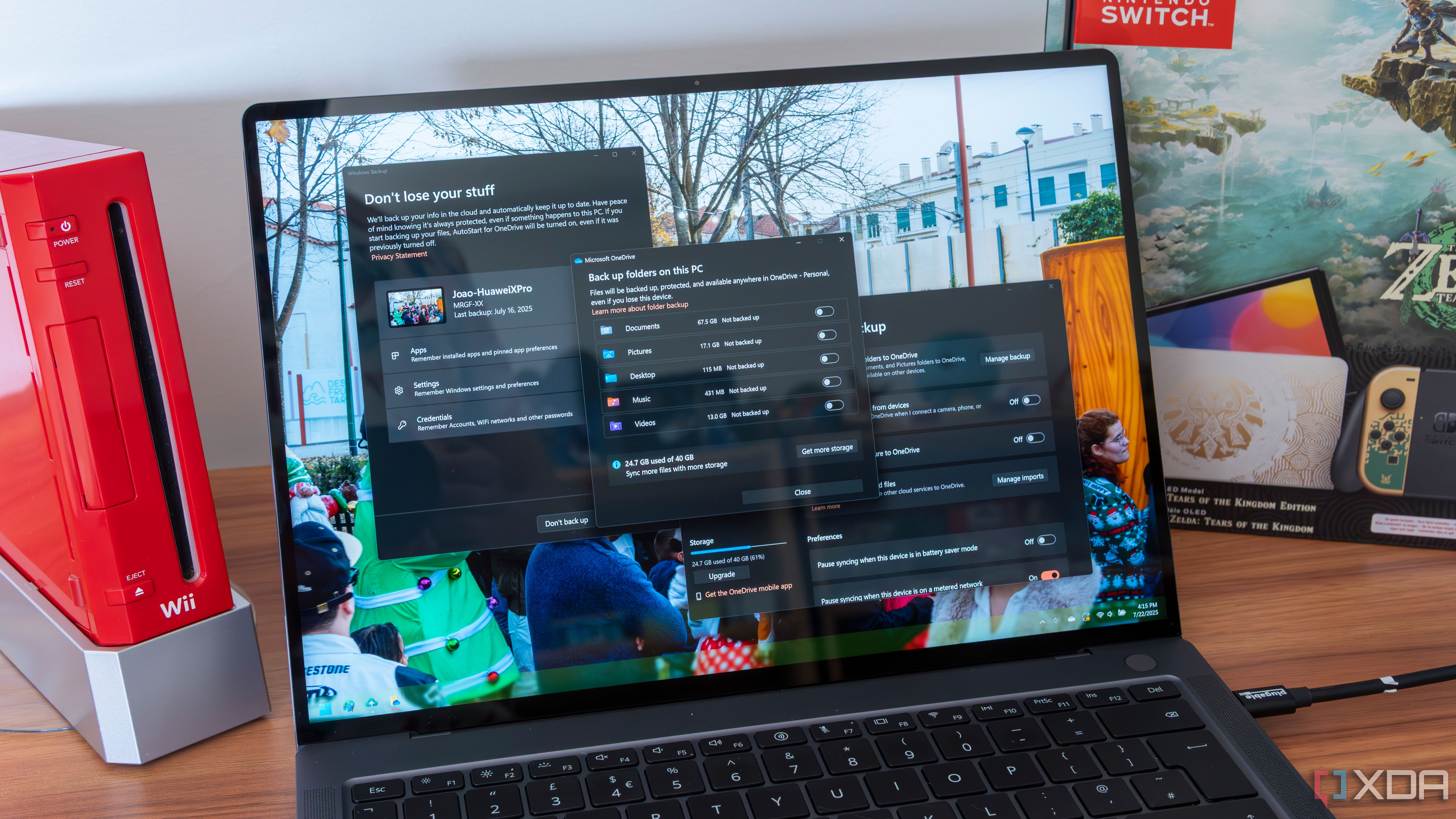 A Windows 11 laptop showing Windows backup and OneDrive backup options