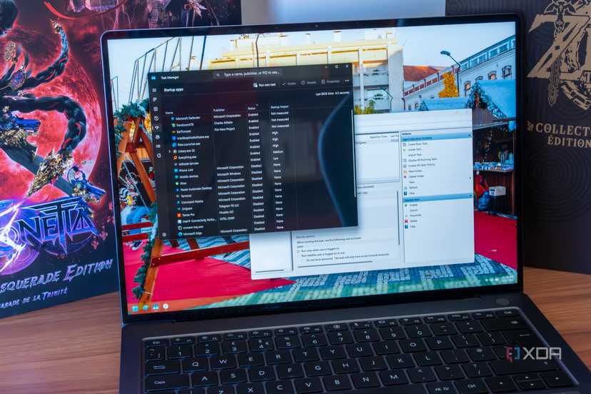 A Windows 11 laptop showing startup tasks in Task Manager and Task Scheduler