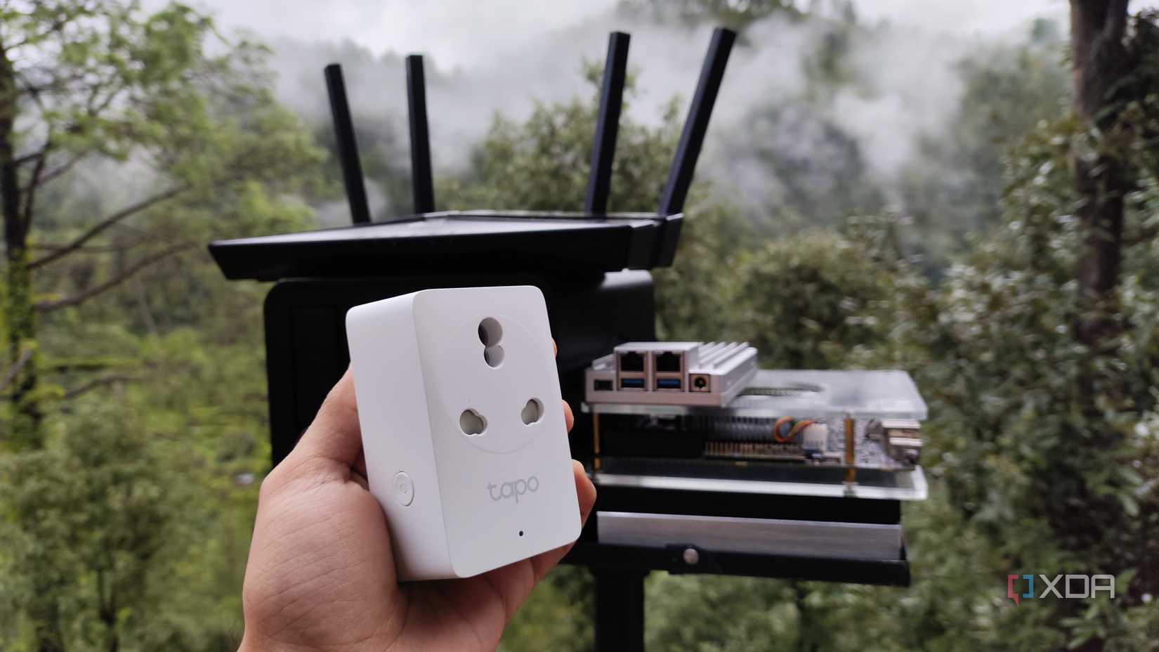 Holding a smart plug in front of some home lab devices